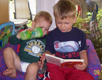 Nicholas loves to sit on the Wiggles sofa  to hear Tommy read to him!