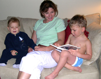 Tommy reads to Nicholas and Mom.