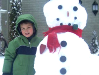 Tall snowman with a big kid!