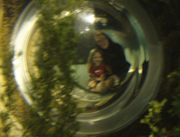 Corah and Randi through an underwater porthole.