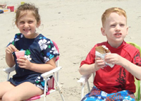 Sister and brother have a snack.
