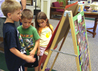 Looking at Tommy's reading award photo at the library.
