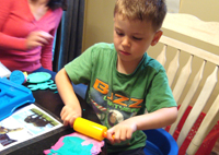 Nicholas rolls the Play Doh.