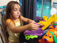 Ophelia plays with Play Doh.