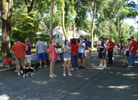 The neighborhood plays softball on the 4th of July.