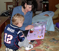 Here's a little Patriot reading up on game strategy with Mom and Nicholas.