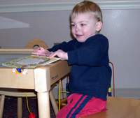 Tommy plays in the kids waiting room.