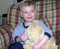 Tommy tickles Baby Bear.