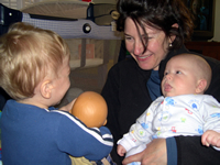 Tommy has fun with Mommy and Nicholas.