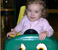 Victoria in a dinosaur stroller
