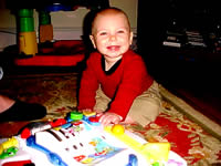 Tommy plays with his little Leap Frog table.